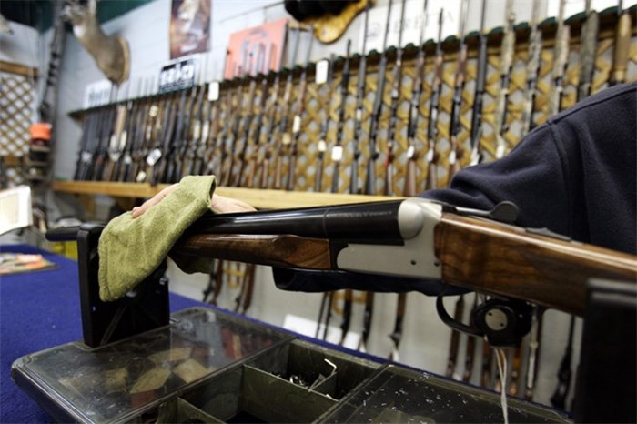  The Liberal government is planning to introduce long-promised legislation as early as Tuesday to strengthen controls on the sale, licensing and tracing of guns. A Ottawa hunting store salesperson wipes a shotgun on Tuesday, May 16, 2006. THE CANADIAN PRESS/Jonathan Hayward