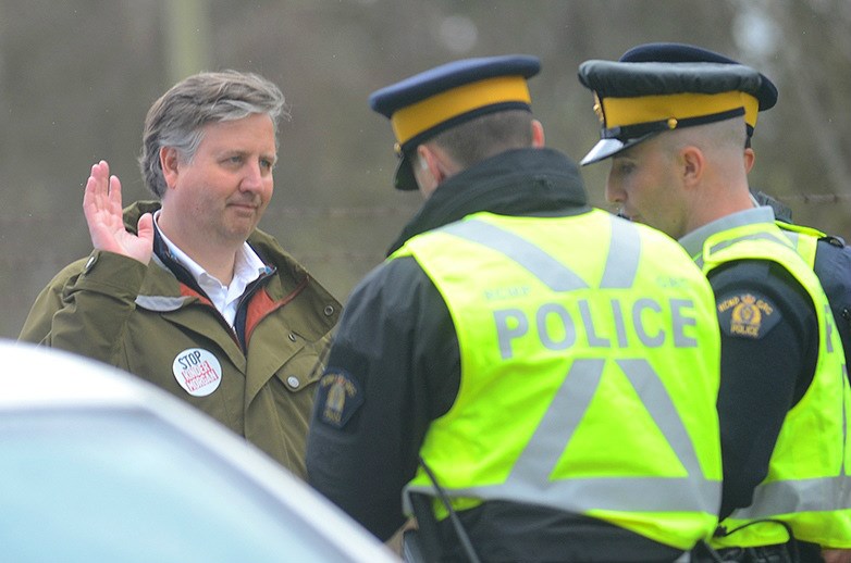  Kennedy Stewart speaks to police officers after being arrested outside the Kinder Morgan terminal in Burnaby. - Cornelia Naylor