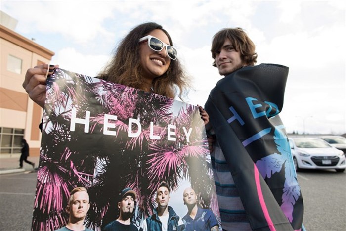  Hedley fan's Charene Gonschorek, left, and Brandon Krys show their support for the band before the final concert of their current tour in Kelowna, B.C., on Friday, March 23, 2018. The band's tour has been overshadowed by allegations of sexual misconduct. The band was dropped from their management company, The Feldman Agency, their songs were pulled from radio stations across the country and a planned performance at the Juno Awards was cancelled. Following the tour, Hedley has announced that they will be taking an indefinite hiatus from music. THE CANADIAN PRESS/Jeff Bassett