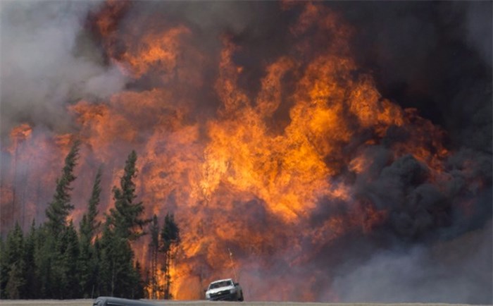 A giant fireball is seen as a wild fire rips through the forest 16 km south of Fort McMurray, Alberta on highway 63 on May 7, 2016. Canadians seeking updates on public emergencies will soon have to look no further than their mobile phones. THE CANADIAN PRESS/Jonathan Hayward