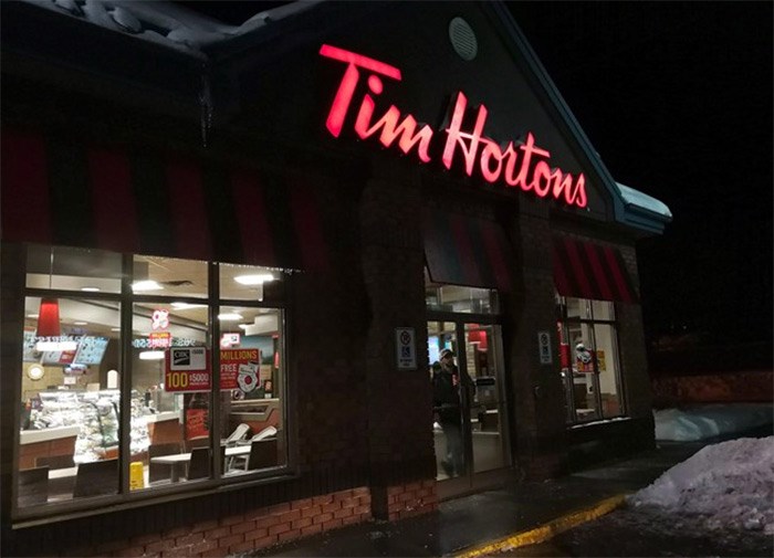  A customer walks out of a Tim Hortons restaurant in Newcastle, Ontario on Sunday Feb. 11, 2018. THE CANADIAN PRESS/Doug Ives