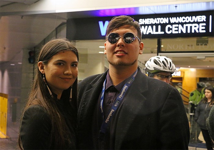  Cedar George-Parker from the Tsleil-Waututh First Nation (right) with fellow protester Amelia Boissoneau . George-Parker was peacefully removed from the Sheraton Wall Centre while rapping the lyrics to a Migos song after he interrupted Prime Minister Justin Trudeau’s speech to Liberal donors. Photo Saša Laki?