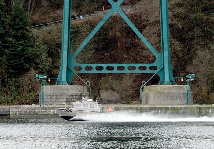  Harbour service vessel Tymac Spray cuts through the water next to the Lions Gate Bridge’s south tower. The province is planning to build a rock berm around the support column to protect it from ships drifting off course. photo Mike Wakefield, North Shore News
