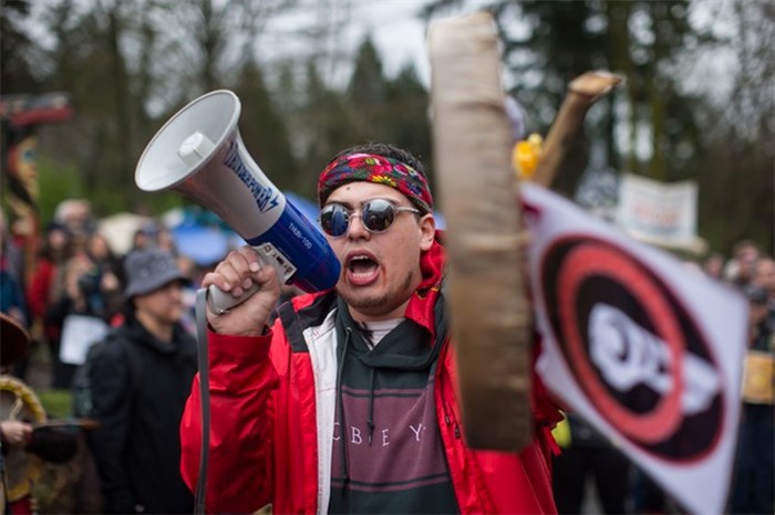  Cedar George-Parker addresses the crowd as protesters opposed to the Kinder Morgan Trans Mountain pipeline extension defy a court order and block an entrance to the company's property, in Burnaby, B.C., on Saturday April 7, 2018. The pipeline is set to increase the capacity of oil products flowing from Alberta to the B.C. coast to 890,000 barrels from 300,000 barrels. THE CANADIAN PRESS/Darryl Dyck