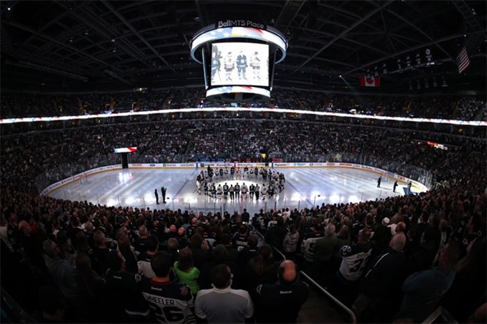  Winnipeg Jets and the Chicago Blackhawks come together at centre ice wearing Broncos on the back of their jerseys for a moment of silence for the Humboldt Broncos bus crash victims before NHL action in Winnipeg on Saturday, April 7, 2018. THE CANADIAN PRESS/John Woods
