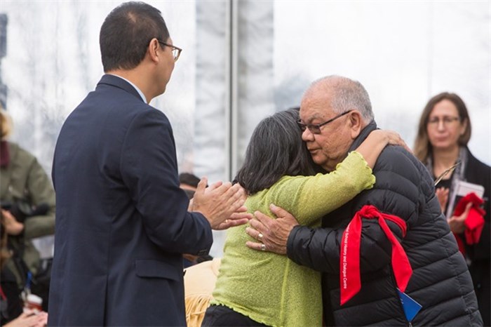  Barney Williams Jr., a residential school survivor, hugs Cindy Tom-Lindley a former student at the Kamloops Indian Residential School near UBC President Santa Ono during the opening of the Indian Residential School History and Dialogue Centre at UBC in Vancouver, B.C., on Monday April 9, 2018. THE CANADIAN PRESS/Ben Nelms