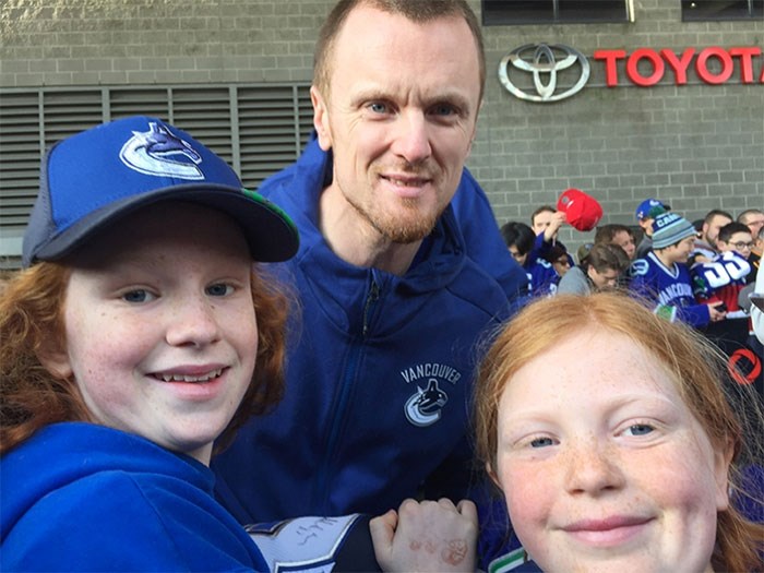  SEDIN SIGHTING: Powell River sisters Lily  and Marin Carlos, seen here with Vancouver Canucks assistant captain Henrik Sedin, met their hockey heroes at a recent Canucks game in Vancouver. Contributed photo