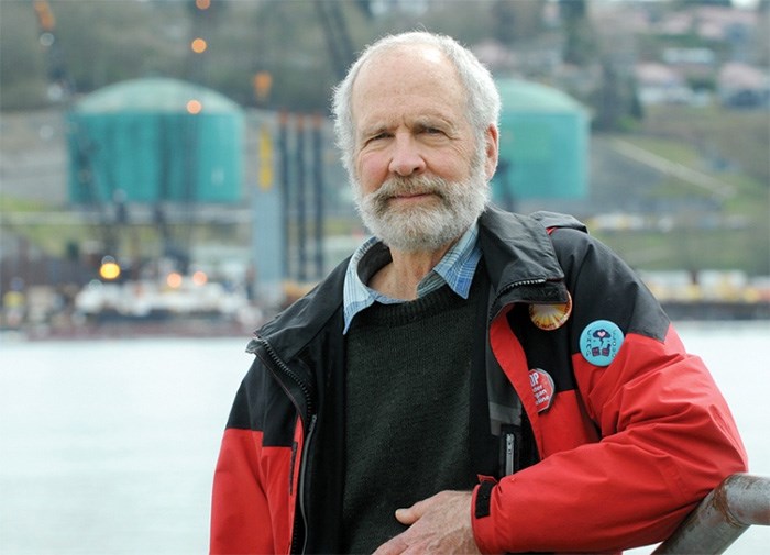  Climate change protester and North Vancouver resident Gordon Cornwall is questioning whether Kinder Morgan is serious about halting non-essential work on Kinder Morgan’s Trans Mountain’s pipeline. In the background crews continue their work on the Westridge terminal in Burnaby. photo Mike Wakefield, North Shore News