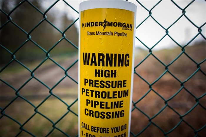  A sign warning of an underground petroleum pipeline is seen on a fence at Kinder Morgan's facility. THE CANADIAN PRESS/Darryl Dyck