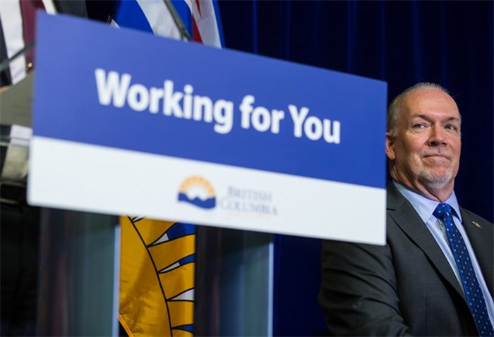  British Columbia Premier John Horgan listens during a housing announcement in Coquitlam, B.C., on Friday April 13, 2018. British Columbia's government has issued a progress report on permits for the Trans Mountain pipeline expansion, just as Horgan readies to travel to Ottawa for a meeting on the controversial project. THE CANADIAN PRESS/Darryl Dyck