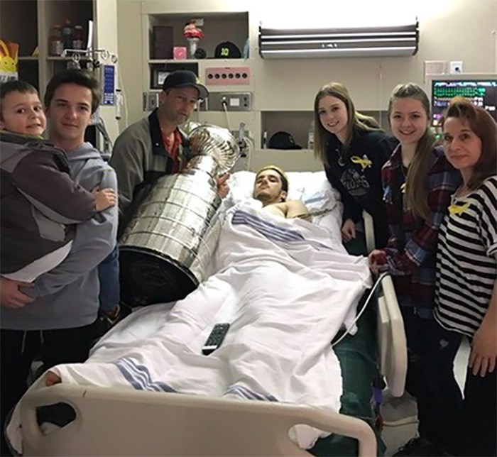  Ryan Straschnitzki, centre, poses with brothers Connor, left to right, and Jett, father Tom, girlfriend Erica, sister Jaden and mother Michelle as they pose with the Stanley Cup at Royal University Hospital in Saskatoon in this recent handout photo. The Stanley Cup has visited the hospital bedsides of Humboldt Broncos who survived a deadly bus crash. THE CANADIAN PRESS/HO - Tom Straschnitzki