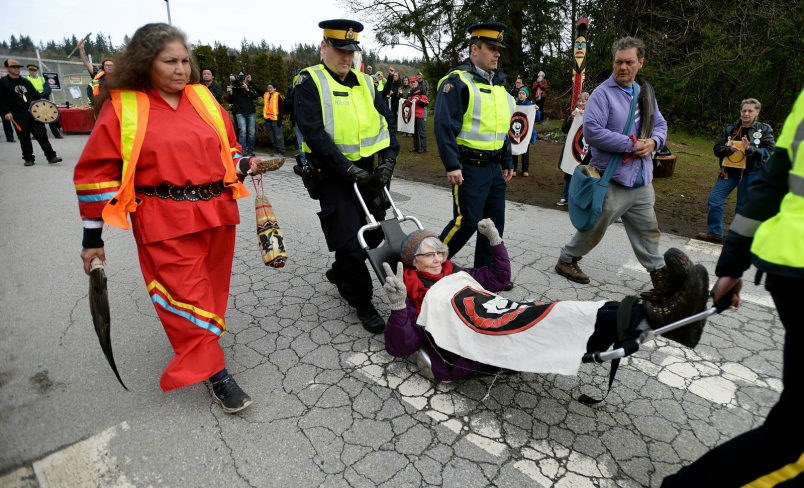  Protester Nan Gregory is carried away by Burnaby RCMP after protesting at the Trans Mountain terminal in Burnaby on Friday.