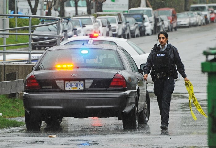  A North Vancouver RCMP officer prepares to cordon off access to the Spirit Trail following a bomb threat at Bodwell Highschool. photo Cindy Goodman, North Shore News
