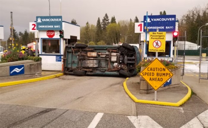  A van came to rest wedged between two toll booths after it flipped on its side at the Langdale Ferry Terminal Saturday evening.