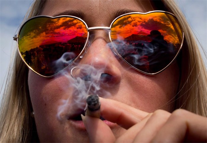  Thousands are expected to attend the 4-20 marijuana smoke-in at Vancouver's Sunset Beach Friday, and while the legalization goal of the annual Weed Day will soon be met, an event organizer says there is much more to protest. A woman smokes a joint during the annual 4-20 cannabis culture celebration at Sunset Beach in Vancouver, B.C., on Thursday, April 20, 2017. THE CANADIAN PRESS/Darryl Dyck