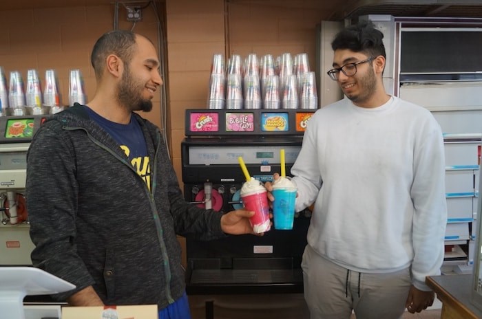  Mehdi Khataw (left) and brother Mikail Khataw cheers to some of the last Danny’s Screamers they may be tasting. They have different career ambitions, leaving father Abbas to close the longtime, family-run business. (Photo: Graeme Wood)