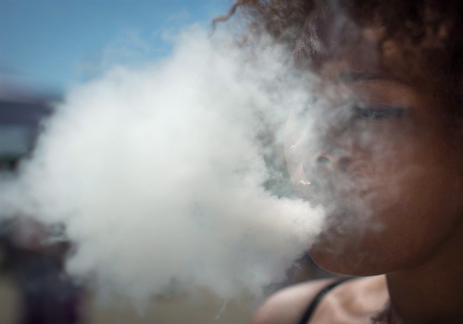  Woman exhales after taking a hit from a bong during the annual 4/20 cannabis culture celebration at Sunset Beach in Vancouver, B.C., on Wednesday April 20, 2016. The Society of Obstetricians and Gynecologists is warning pregnant and breastfeeding women about the potential dangers of cannabis use. THE CANADIAN PRESS/Darryl Dyck