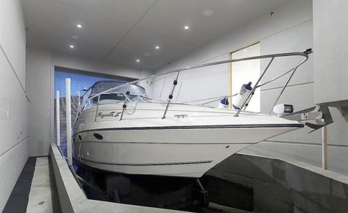  Yes, you read it right: the seller is throwing in this jaw-dropping 32-foot boat into the home package. Well, it fits the boat house so perfectly... Listing agent: Malcolm Hasman
