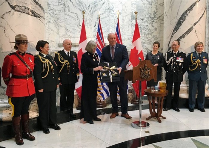  B.C. Premier John Horgan presents outgoing BC Lt.-Gov. Judith Guichon with a saddle pad for her horse in Victoria on Monday, April 23, 2018. Guichon is a life long rancher from Merritt, B.C. The saddle pad is embroidered with the official crest of B.C. and her office. THE CANADIAN PRESS/Dirk Meissner