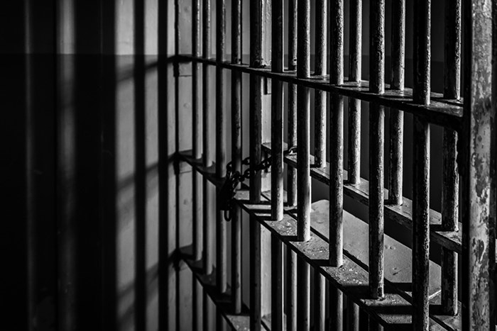  A Surrey man convicted of mail theft has been sentenced to three years in jail. Prison/Shutterstock