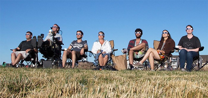  Jim Ryan and his family have incorporated this new reality into their lives. Here they gather together to watch the eclipse.