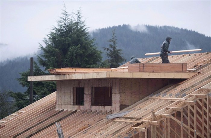  Builders work on a new home in North Vancouver, B.C. Thursday, Oct. 27, 2016. The Real Estate Board of Greater Vancouver says market conditions in the city are changing as sales in April reached a 17-year low for that month. THE CANADIAN PRESS/Jonathan Hayward