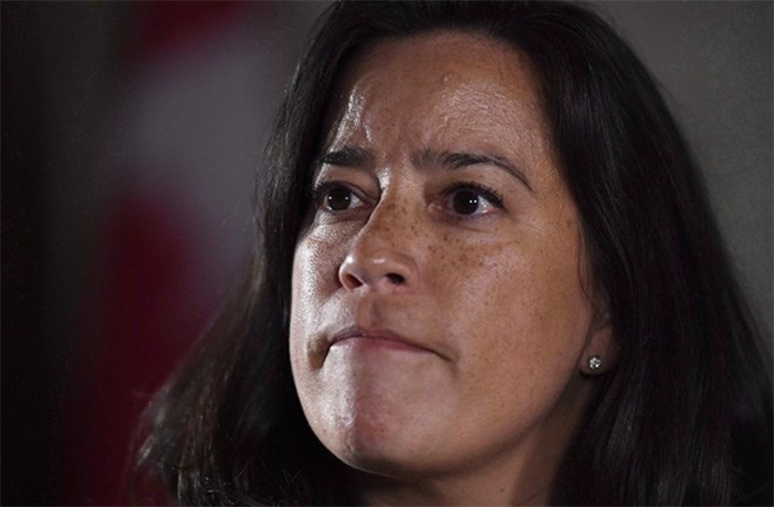  Minister of Justice and Attorney General of Canada Jody Wilson-Raybould listens to a question as she speaks to reporters following Question Period in the Foyer of the House of Commons on Parliament Hill in Ottawa on Wednesday, Feb. 7, 2018. Wilson-Raybould says the federal government will intervene in the British Columbia court case over the Trans Mountain pipeline expansion project. THE CANADIAN PRESS/Justin Tang