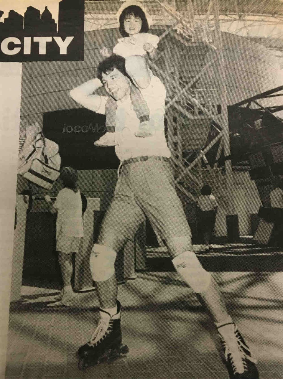  Roller Blades, the latest in fast footwear, have made a hit at Expo 86. CN Pavilion hosts and hostesses are using them to move around the open air pavilion. Here, Randy Jordan gives a young pavilion visitor a quick twirl around the plaza. Roller Blades are a cross between ice skates and roller skates and made in Canada by an Edmonton firm.