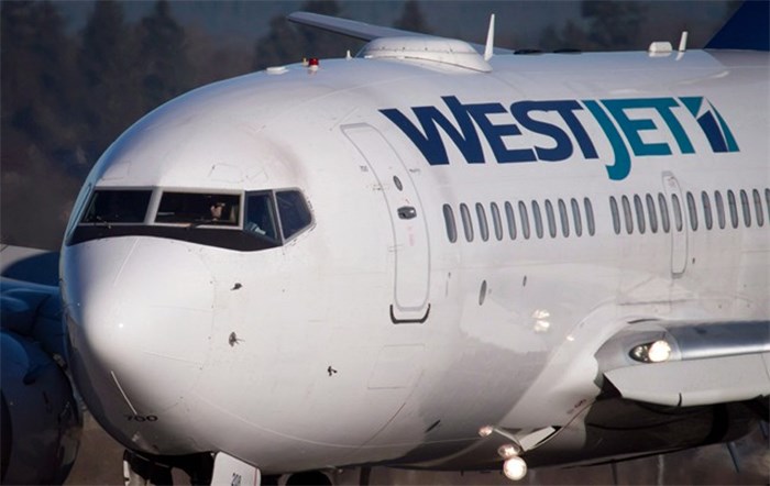  A pilot taxis a Westjet Boeing 737-700 plane to a gate after arriving at Vancouver International Airport in Richmond, B.C., on Monday February 3, 2014. WestJet Airlines said it is severing ties with airfare finder app Hopper due to confusion over the developer's announcement the airline would offer 