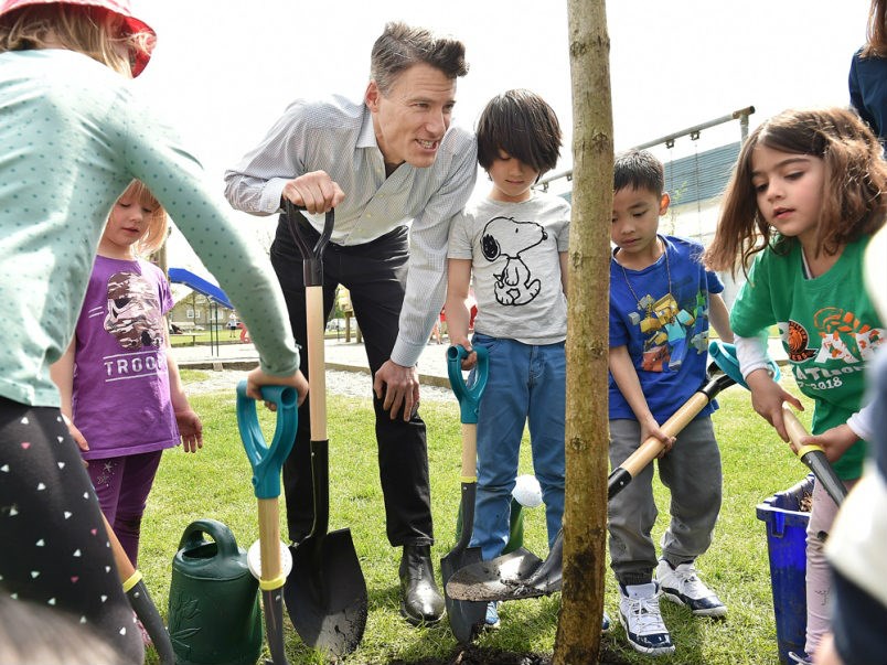  Mayor Gregor Robertson talks to a group of kindergarten students from Lord Nelson school during a tree planting event at Templeton Park Thursday. Since 2010, the city and park board have planted more than 105,000 trees in the city with the goal of reaching 150,000 by 2020. Photo Dan Toulgoet