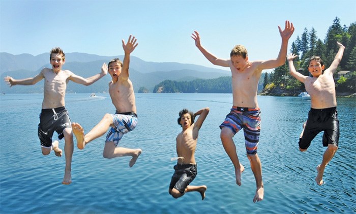  A group of teens leap from the wharf in Deep Cove in July 2015. file photo Cindy Goodman, North Shore News