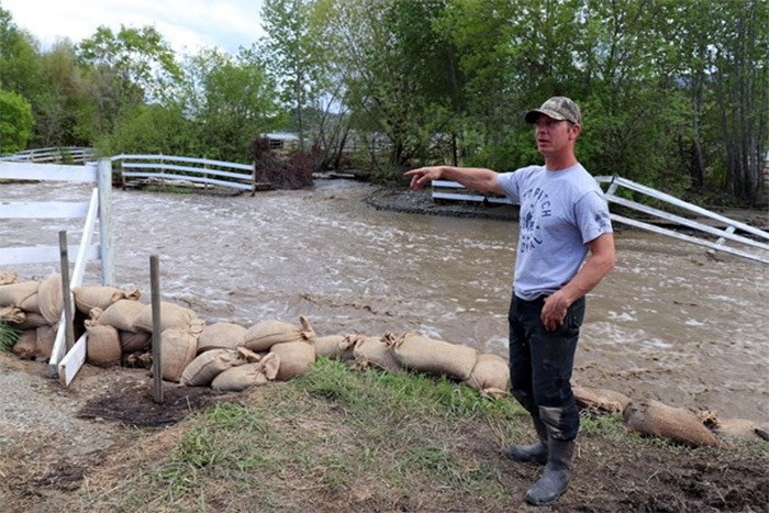  Alan Schmidt, a Cherry Creek resident, points to damage on his property a week ago. (via Brendan Kergin)