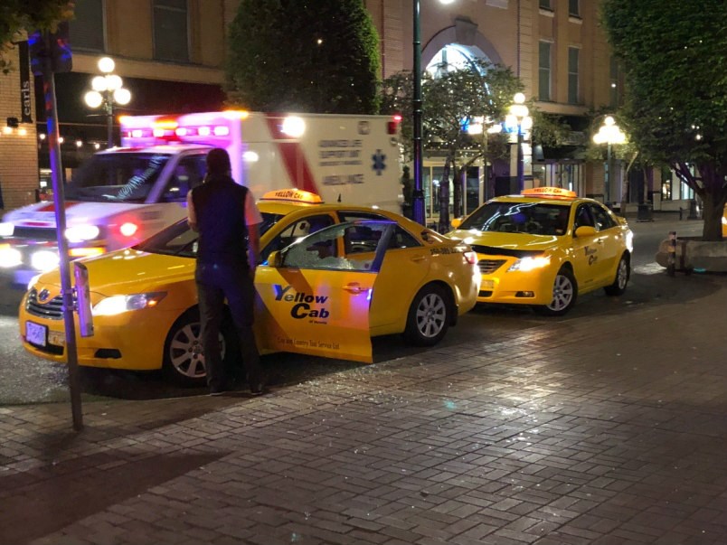  A cab was damaged by a man who attacked several people with a wooden stick in downtown Victoria Photograph By TIMES COLONIST