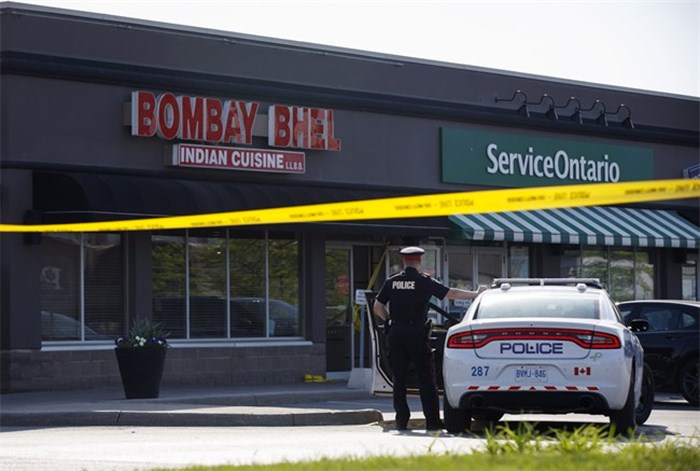  A Police officer stands watch at the scene of an explosion at a restaurant in Mississauga, Ont. on Friday, May 25, 2018. THE CANADIAN PRESS/Cole Burston