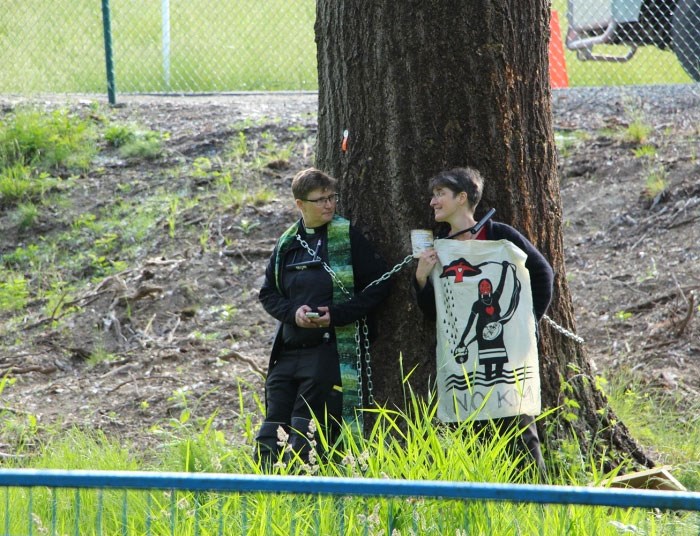  Anglican priest Laurel Dykstra (left) and parishoner Lini Hutchings chain themselves to a tree west of the Trans Mountain terminal on Burnaby mountain Friday (May 25) morning. Photo Lauren Boothby