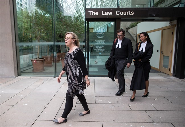  Green Party Leader Elizabeth May, left, and her lawyers Alexander Ejsmony, centre, and Andi Mackay leave B.C. Supreme Court in Vancouver, on Monday May 28, 2018, after May pleaded guilty to a criminal contempt of court charge for violating an injunction at a Kinder Morgan work site. May, who was arrested in March at a Trans Mountain pipeline terminal in Burnaby when she joined activists, was ordered by a judge to pay a $1,500 fine. THE CANADIAN PRESS/Darryl Dyck