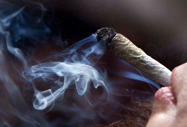  A young man smokes a marijuana joint during a rally in downtown Vancouver, B.C., on Wednesday April 20, 2011. THE CANADIAN PRESS/Darryl Dyck