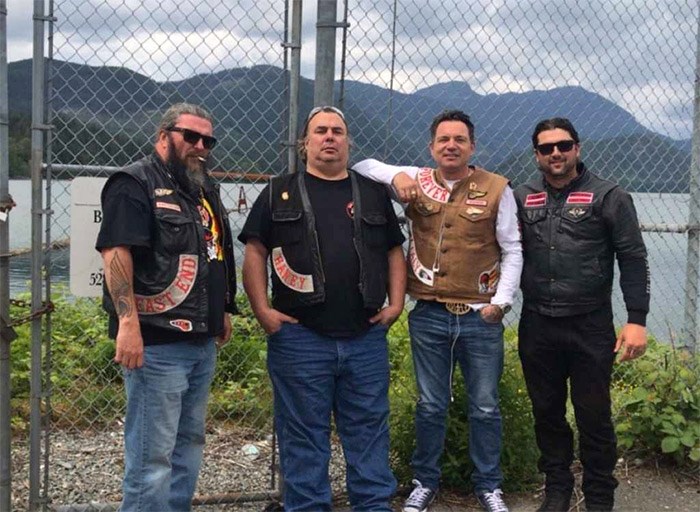  Burnaby firefighter Nick Elmes, right, poses with members of the Hells Angels Motorcycle Club.