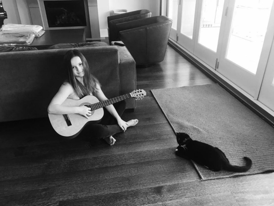  Victoria Anthony with her guitar and her cat Momo. Photo contributed