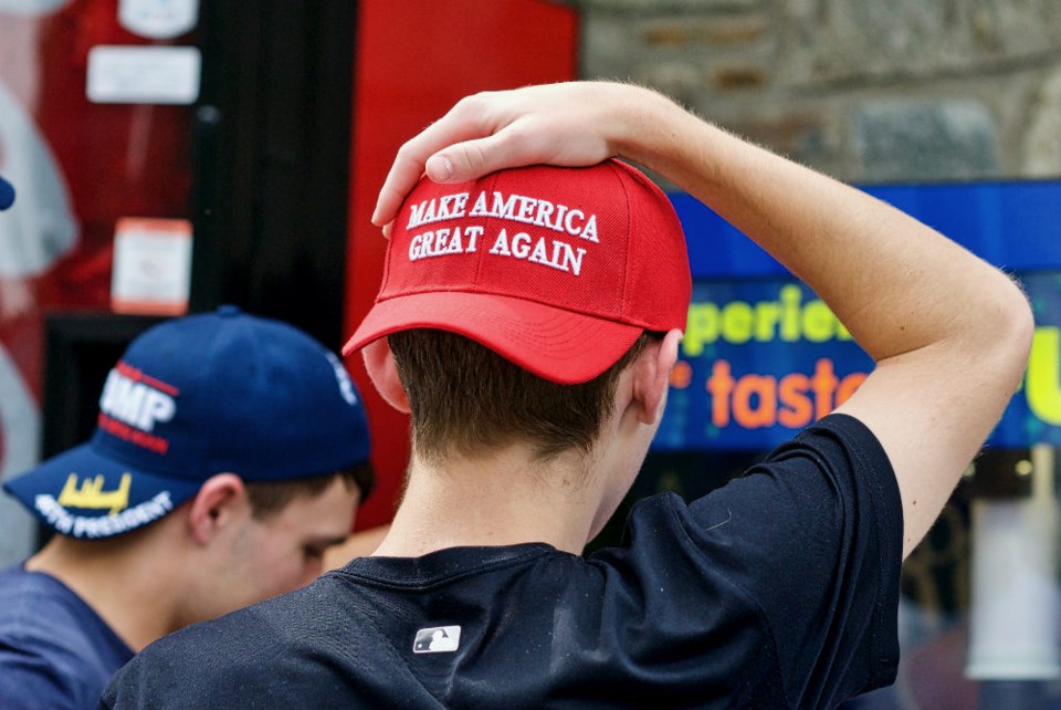  Washington, DC - October 6, 2017: Two unidentified men display their support for President Donald J. Trump through the hats they are wearing during a visit to the National Zoo. Photo John M. Chase via Shutterstock