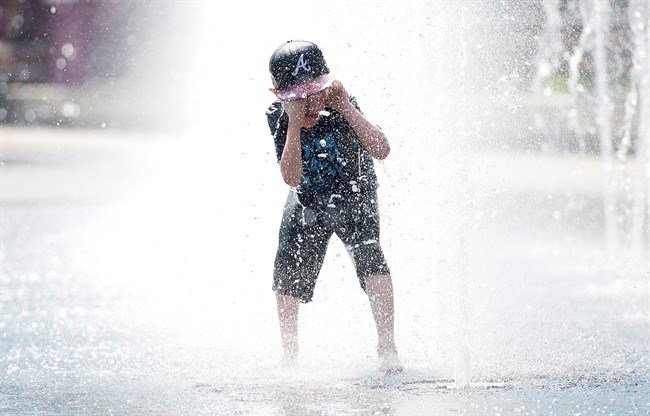  University of Waterloo climate scientist Blair Feltmate says the scorching heat wave that set records in Ontario and Quebec over the Canada Day long weekend can't be directly attributed to climate change. Seven-year-old Samuel Bedard from Quebec City runs through a water fountain as he beats the heat in Montreal, Monday, July 2, 2018. THE CANADIAN PRESS/Graham Hughes