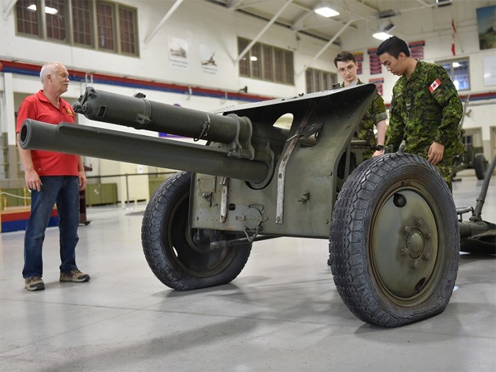  Leon Jensen (left) along with bombardier Bojan Aleksic (centre) and gunner Guan Joseph have a look at the newly-acquired 18 Pounder First World War Howitzer at the Bessborough Armoury. Photo Dan Toulgoet