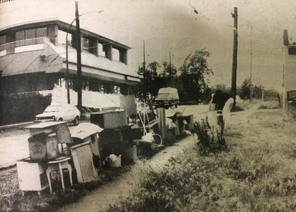  A pile of furnishings lay on the boulevard at East Sixteenth and Carolina Tuesday. By Wednesday the Umbrella Man (background) and an old woman, who had lived on the street, were gone. Photo Ethan Minovitz