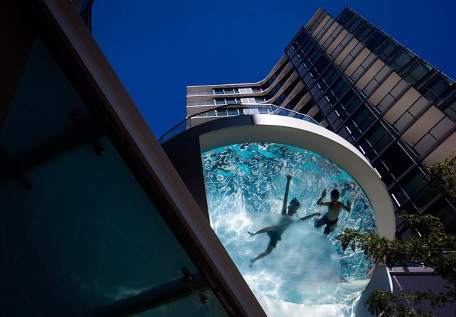  Two boys swim in a pool at a condo in downtown Vancouver, B.C., on Thursday, August 18, 2016. Environment Canada has issued weather warnings as parts of southern British Columbia brace for several days of withering heat. THE CANADIAN PRESS/Darryl Dyck