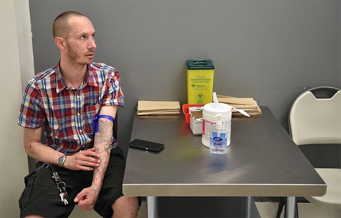  Colin Ross at the Pier Health Resource Centre near Main and Hastings, preparing to inject liquid hydromorphone into his arm. Photo Dan Toulgoet