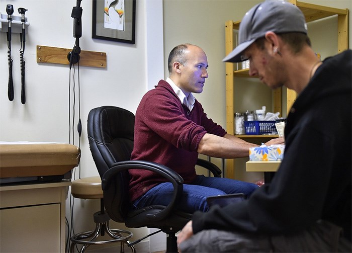  Dr. David Tu meeting in his office with Colin Ross. Photo Dan Toulgoet