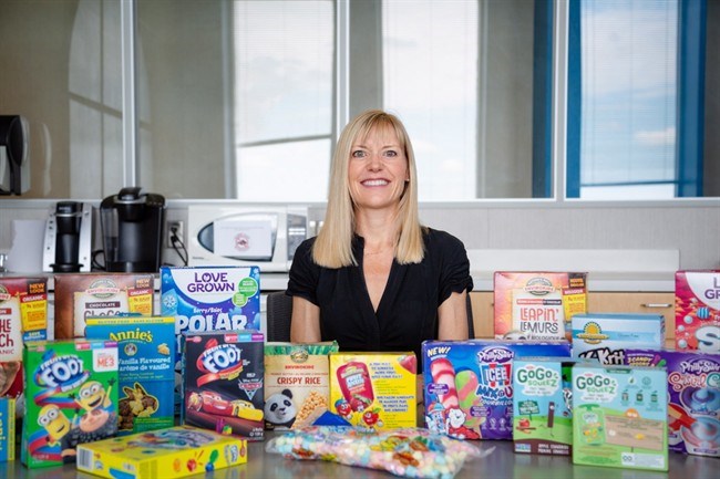  Charlene Elliott, of the University of Calgary, poses with an array of gluten-free packaged foods marketed for children in an undated handout photo. THE CANADIAN PRESS/HO-University of Calgary, Debby Herold