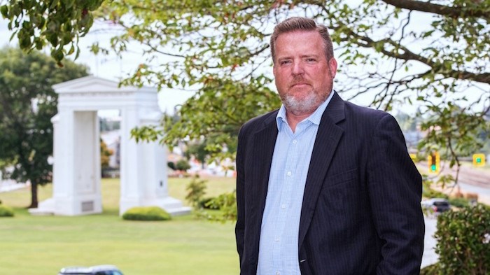  Blaine Immigration lawyer Len Saunders stands with the Peace Arch in the background, a short walk from his Blaine practice (Photo: Chung Chow)