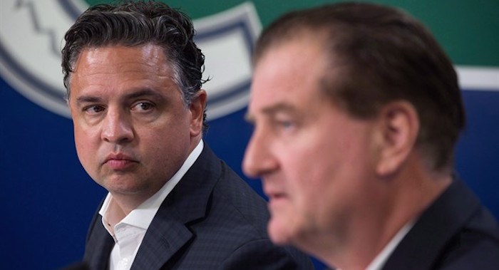  Vancouver Canucks' head coach Travis Green, left, listens as General Manager Jim Benning responds to questions during a news conference ahead of the opening of the NHL hockey team's training camp, in Vancouver, B.C., on Tuesday September 12, 2017. THE CANADIAN PRESS/Darryl Dyck