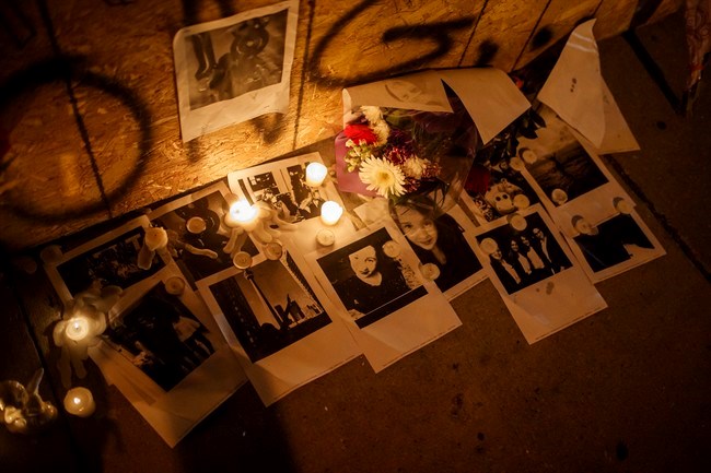  Pictures of Danforth shooting victim Reese Fallon, are left with candles at a makeshift memorial remembering the victims of a shooting on Sunday evening on Danforth, Ave. in Toronto on Monday, July 23, 2018. THE CANADIAN PRESS/Mark Blinch